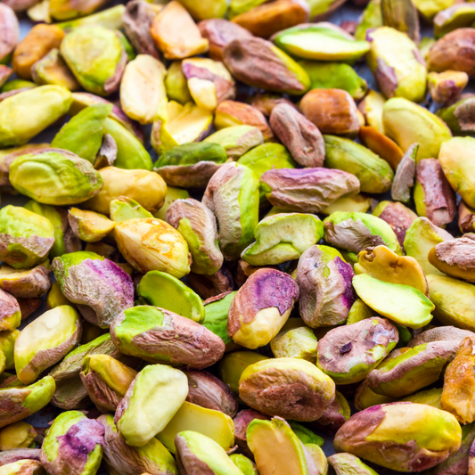 Close-up of fresh and shelled pistachios in a bowl, perfect for healthy eating.
